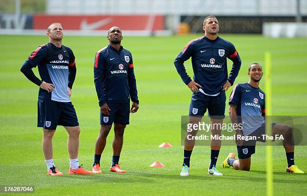 Wayne Rooney, Jermain Defoe, Kyle Walker and Theo Walcott look on during the England training session at St Georges Park on August 12, 2013 in...