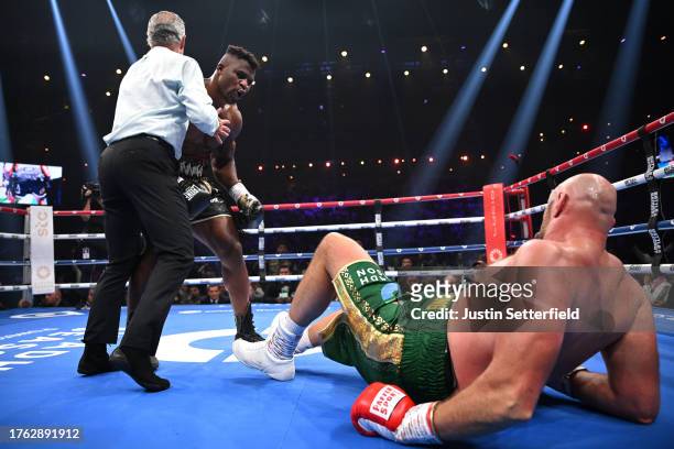 Francis Ngannou knocks down Tyson Fury during the Heavyweight fight between Tyson Fury and Francis Ngannou at Boulevard Hall on October 28, 2023 in...