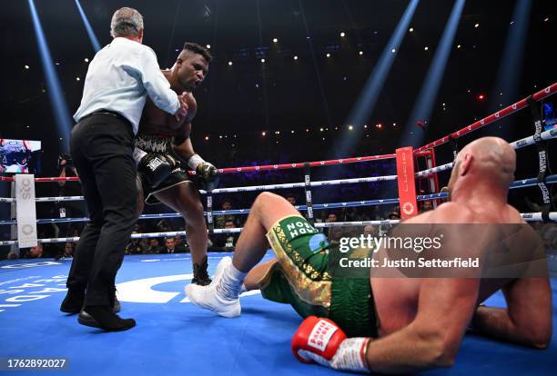 Francis Ngannou knocks down Tyson Fury during the Heavyweight fight between Tyson Fury and Francis Ngannou at Boulevard Hall on October 28, 2023 in...