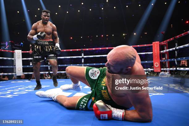 Francis Ngannou knocks down Tyson Fury during the Heavyweight fight between Tyson Fury and Francis Ngannou at Boulevard Hall on October 28, 2023 in...