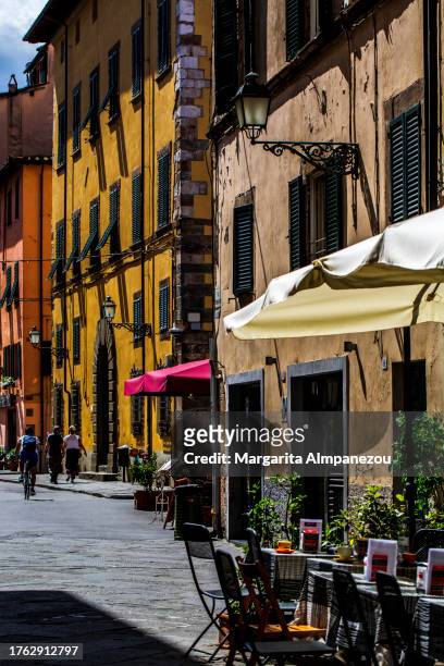 sunny day in the colorful streets of lucca in italy - lucca italy stock pictures, royalty-free photos & images