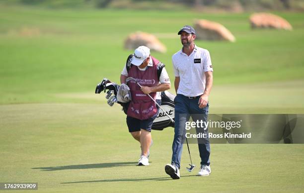 Scott Jamieson of Scotland walks with his caddie on the fourth hole during Day Four of the Commercial Bank Qatar Masters at Doha Golf Club on October...