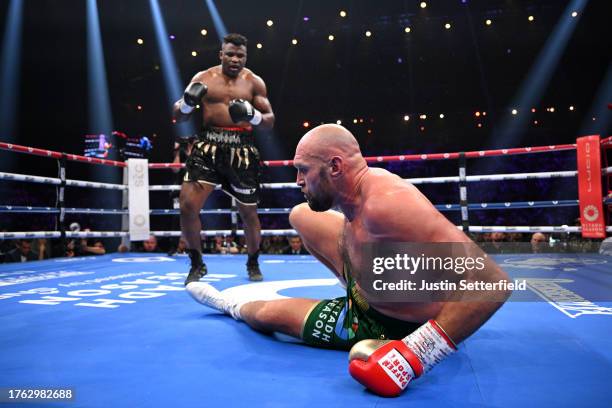 Francis Ngannou knocks down Tyson Fury during the Heavyweight fight between Tyson Fury and Francis Ngannou at Boulevard Hall on October 28, 2023 in...