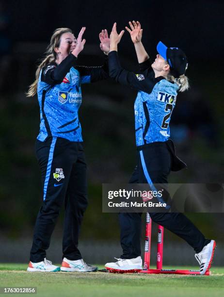 Amanda-Jade Wellington of the Adelaide Strikers celebrates the wicket of Mignon Du Preez of the Brisbane Heat with Katie Mack of the Adelaide...