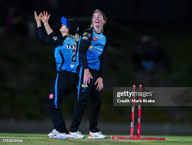 Amanda-Jade Wellington of the Adelaide Strikers celebrates the wicket of Mignon Du Preez of the Brisbane Heat with Katie Mack of the Adelaide...