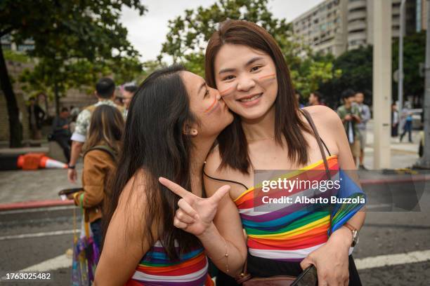 Young woman kissing another young woman at the 2023 Taiwan LGBT+ Pride where over 180,000 have gathered to celebrate and advocate for civil rights...