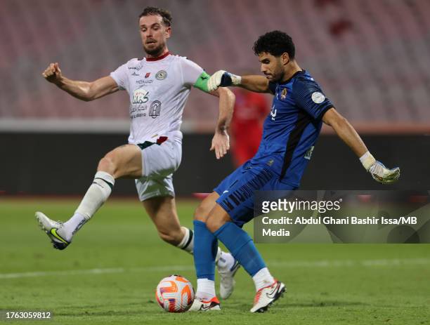 Jordan Henderson of Al Ettifaq pressures Al Wehda goalkeeper Munir Mohamedi during the Saudi Pro League match between Al Wehda v Al Ettifaq at King...