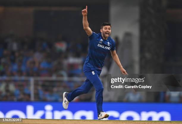 Mark Wood of England celebrates the wicket of Mohammad Shami of India during the ICC Men's Cricket World Cup India 2023 between India and England at...