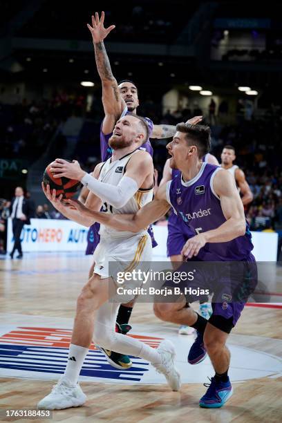 Dzanan Musa of Real Madrid and Chumi Ortega of Zunder Palencia in action during ACB League match between Real Madrid and Zunder Palencia at WiZink...