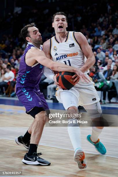 Mario Hezonja of Real Madrid and Vitor Benite of Zunder Palencia in action during ACB League match between Real Madrid and Zunder Palencia at WiZink...