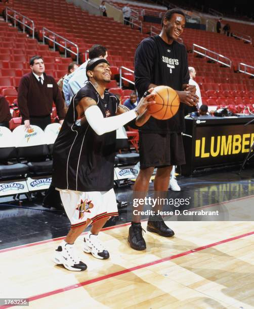 Allen Iverson of the Philadelphia 76ers takes a practice shot with John Salmons before the NBA game against the Atlanta Hawks at First Union Center...