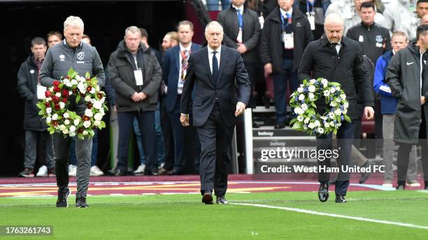 David Moyes of West Ham United, Sean Dyche of Everton and Sir Geoff Hurst walk out with tributes to Sir Bobby Charlton and Bill Kenwright prior to...