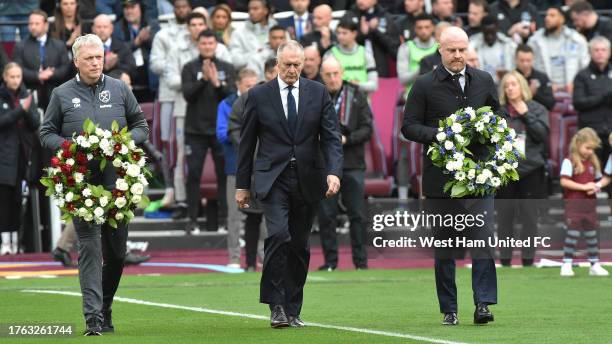 David Moyes of West Ham United, Sean Dyche of Everton and Sir Geoff Hurst walk out with tributes to Sir Bobby Charlton and Bill Kenwright prior to...