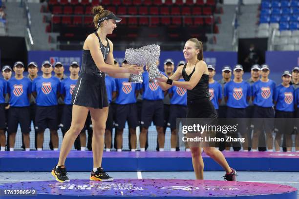 Beatriz Haddad Maia of Brazil and Veronika Kudermetova celebrate with the trophy following they victory of the women's doubles final matche against...