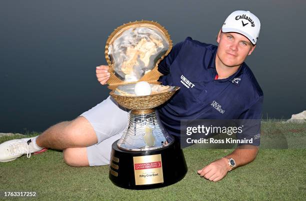 Sami Valimaki of Finland poses with the trophy after victory on the first play-off hole during Day Four of the Commercial Bank Qatar Masters at Doha...