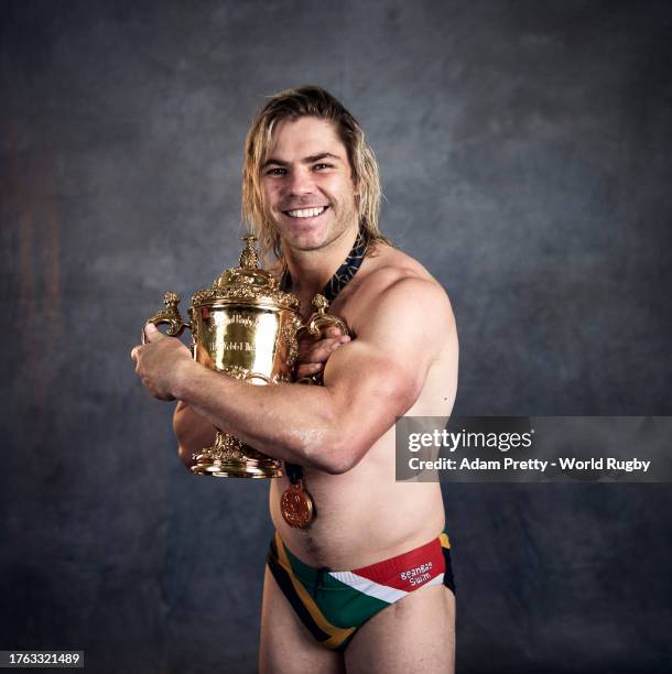 Faf De Klerk of South Africa poses with the Webb Ellis Cup during the South Africa Winners Portrait shoot after the Rugby World Cup Final match...