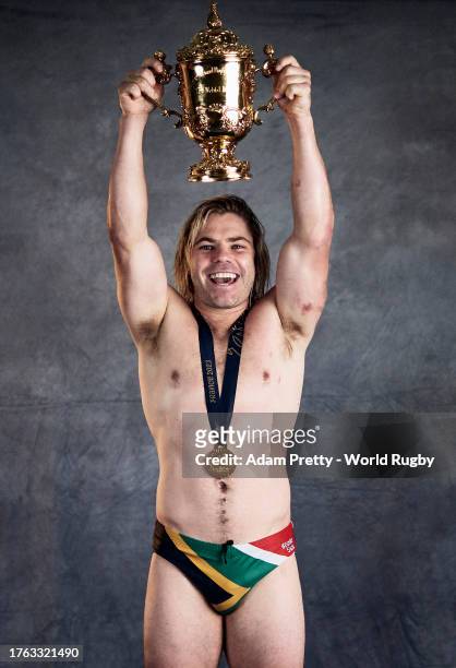 Faf De Klerk of South Africa poses with the Webb Ellis Cup during the South Africa Winners Portrait shoot after the Rugby World Cup Final match...