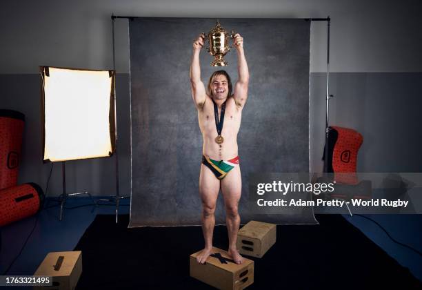 Faf De Klerk of South Africa poses with the Webb Ellis Cup during the South Africa Winners Portrait shoot after the Rugby World Cup Final match...