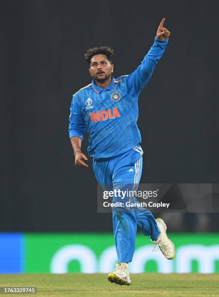 Kuldeep Yadav of India celebrates the wicket of Jos Buttler of England during the ICC Men's Cricket World Cup India 2023 between India and England at...