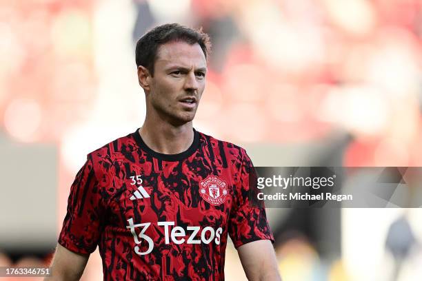 Jonny Evans of Manchester United looks on in the warm up prior to the Premier League match between Manchester United and Manchester City at Old...