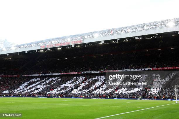 Fans hold up cards to create a mural in remembrance of Sir Bobby Charlton prior to the Premier League match between Manchester United and Manchester...