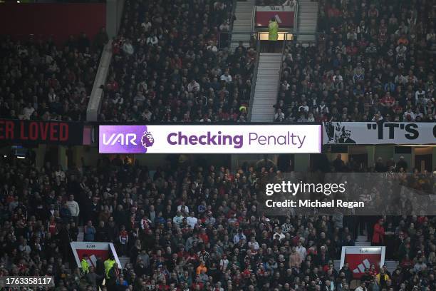 The LED board shows VAR checking for a penalty during the Premier League match between Manchester United and Manchester City at Old Trafford on...