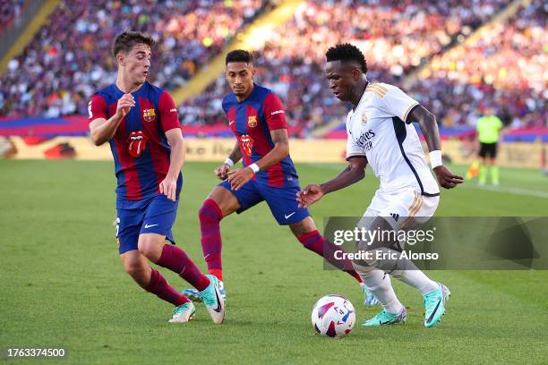 Vinicius Junior of Real Madrid challenges for the ball against Gavi of FC Barcelona during the LaLiga EA Sports match between FC Barcelona and Real...