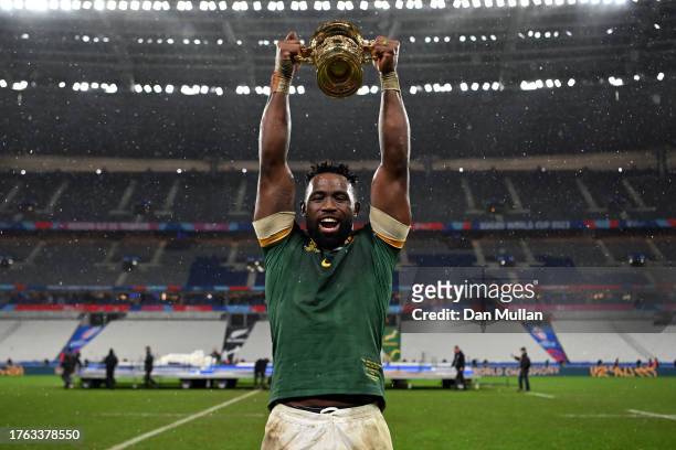 Siya Kolisi of South Africa celebrates with the The Webb Ellis Cup following his side's victory in the Rugby World Cup France 2023 Gold Final match...