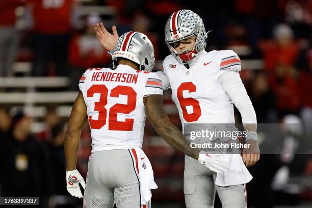 Kyle McCord and TreVeyon Henderson of the Ohio State Buckeyes before the game against the Wisconsin Badgers at Camp Randall Stadium on October 28,...