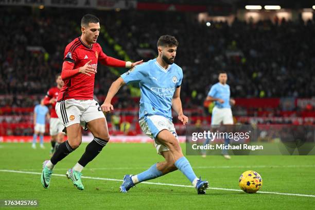 Josko Gvardiol of Manchester City passes the ball whilst under pressure from Diogo Dalot of Manchester United during the Premier League match between...