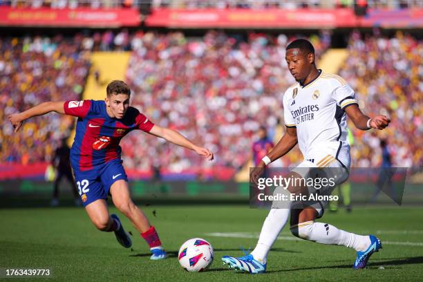 David Alaba of Real Madrid challenges for the ball against Fermin Lopez of FC Barcelona during the LaLiga EA Sports match between FC Barcelona and...