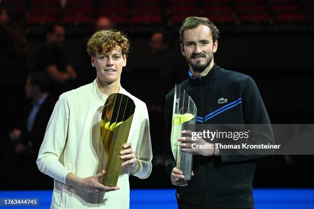 Winner Jannik Sinner of Italy and second placed Daniil Medvedev of Russia pose with their trophies after their final match during day nine of the...