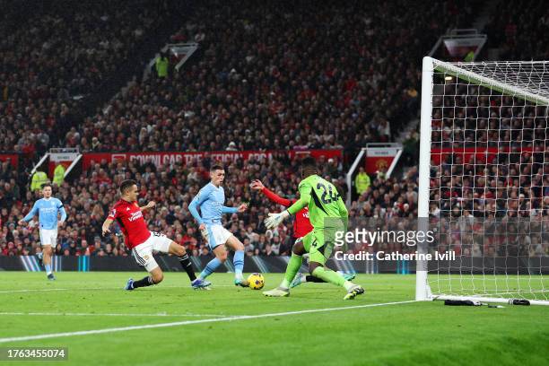 Phil Foden of Manchester City scores the team's third goal during the Premier League match between Manchester United and Manchester City at Old...