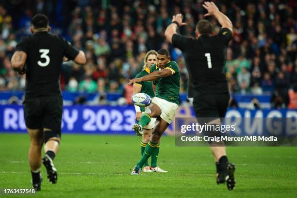 Damian Willemse of South Africa attempts a drop goal under pressure from Ethan de Groot of New Zealand during the Rugby World Cup France 2023 Gold...