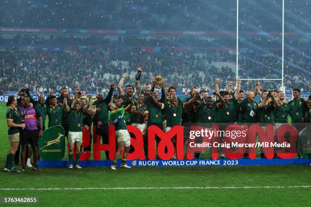 South Africa players and staff celebrate with the Webb Ellis Cup after winning the Rugby World Cup France 2023 Gold Final match between New Zealand...