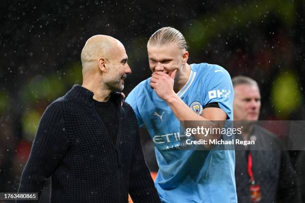 Pep Guardiola, Manager of Manchester City, and Erling Haaland interact after the team's victory in the Premier League match between Manchester United...