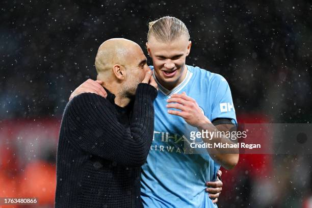Pep Guardiola, Manager of Manchester City, and Erling Haaland interact after the team's victory in the Premier League match between Manchester United...