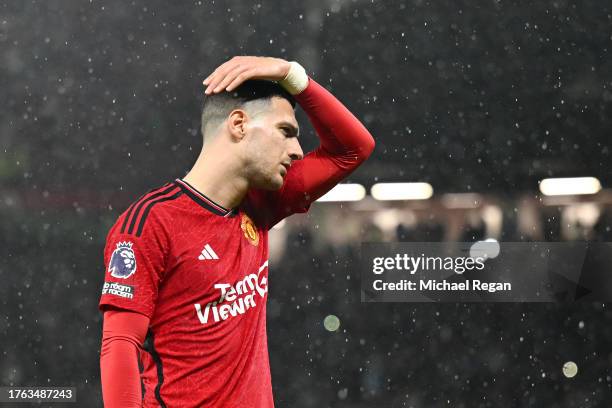 Diogo Dalot of Manchester United looks dejected after the team's defeat in the Premier League match between Manchester United and Manchester City at...