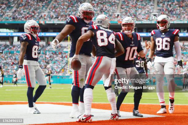 Sidy Sow of the New England Patriots and Mac Jones of the New England Patriots celebrate with Kendrick Bourne of the New England Patriots after...