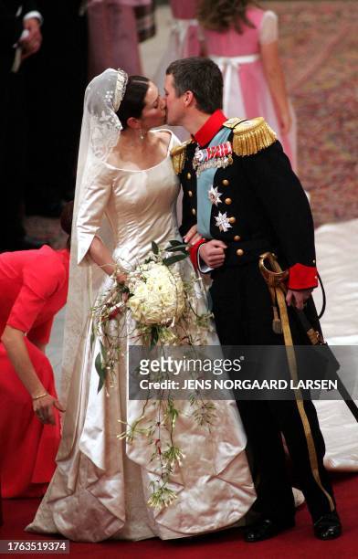 Crown Prince Frederik of Denmark kisses his bride Mary Elizabeth Donaldson after the wedding ceremony at the Copenhagen Cathedral, 14 May 2004.