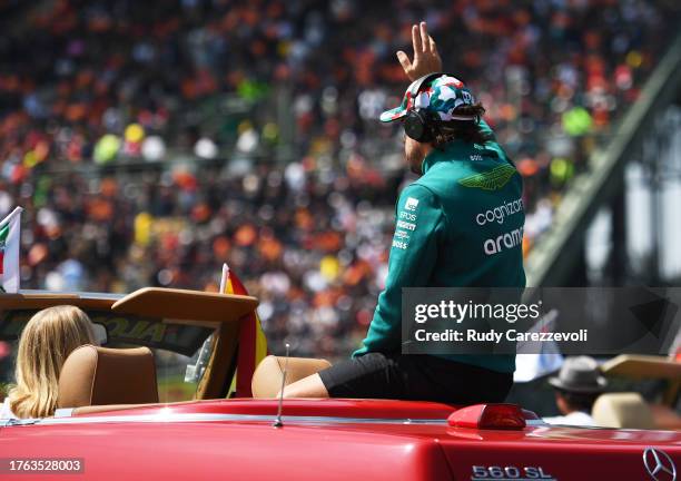 Fernando Alonso of Spain and Aston Martin F1 Team waves to the crowd on the drivers parade prior to the F1 Grand Prix of Mexico at Autodromo Hermanos...