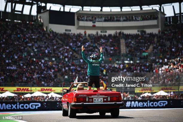 Fernando Alonso of Spain and Aston Martin F1 Team waves to the crowd on the drivers parade prior to the F1 Grand Prix of Mexico at Autodromo Hermanos...