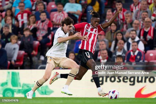 Nico Williams of Athletic Club duels for the ball with Javi Guerra of Valencia CF during the LaLiga EA Sports match between Athletic Bilbao and...