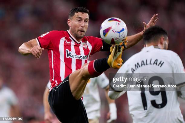 Oscar de Marcos of Athletic Club duels for the ball with Selim Amallah of Valencia CF during the LaLiga EA Sports match between Athletic Bilbao and...