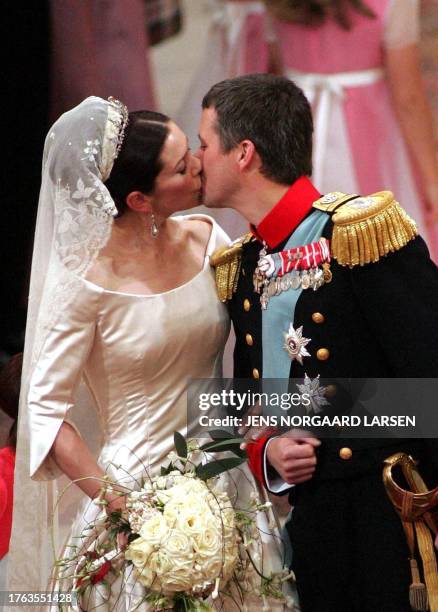 Crown Prince Frederik of Denmark kisses his bride Mary Elizabeth Donaldson after the wedding ceremony at the Copenhagen Cathedral, 14 May 2004.