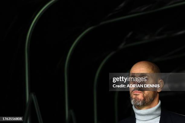 Manchester United's Dutch manager Erik ten Hag arrives to walk on the pitch ahead of the English Premier League football match between Fulham and...