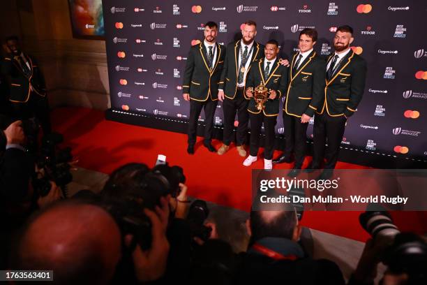 Eben Etzebeth, RG Snyman, Damian Willemse, Franco Mostert and Jean Kleyn of South Africa pose for a photograph with The Webb Ellis Cup on the Red...