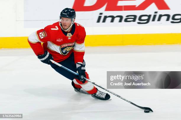 Dmitry Kulikov of the Florida Panthers skates with the puck against the Seattle Kraken at the Amerant Bank Arena on October 28, 2023 in Sunrise,...