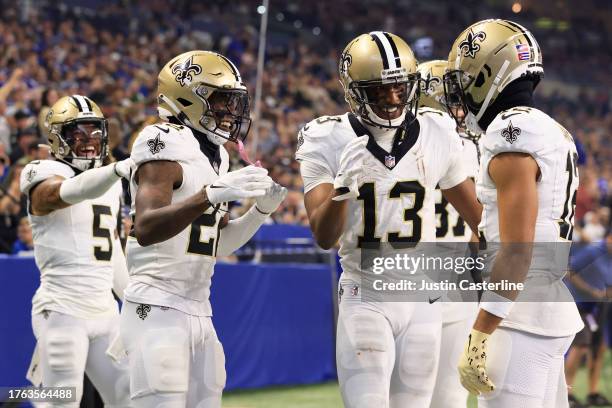 Rashid Shaheed of the New Orleans Saints, Michael Thomas of the New Orleans Saints and Chris Olave of the New Orleans Saints celebrate after...