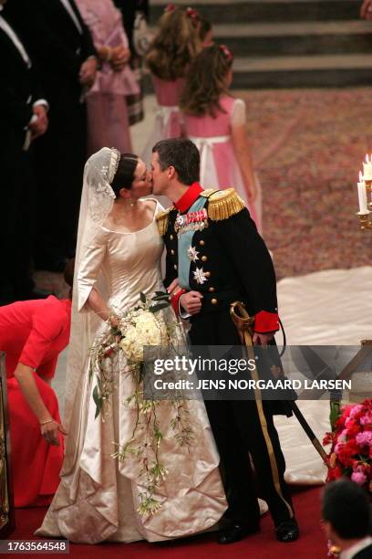 Crown Prince Frederik of Denmark kisses his bride Mary Elizabeth Donaldson after the wedding ceremony at the Copenhagen Cathedral, 14 May 2004.